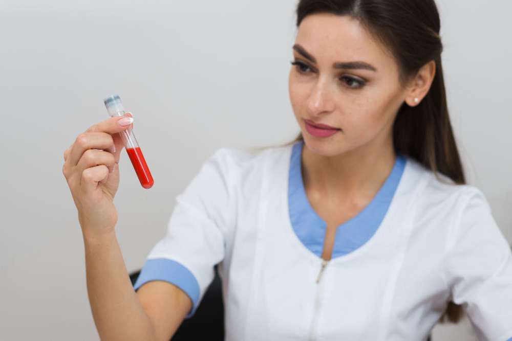 Laboratory technician examining a blood sample tube